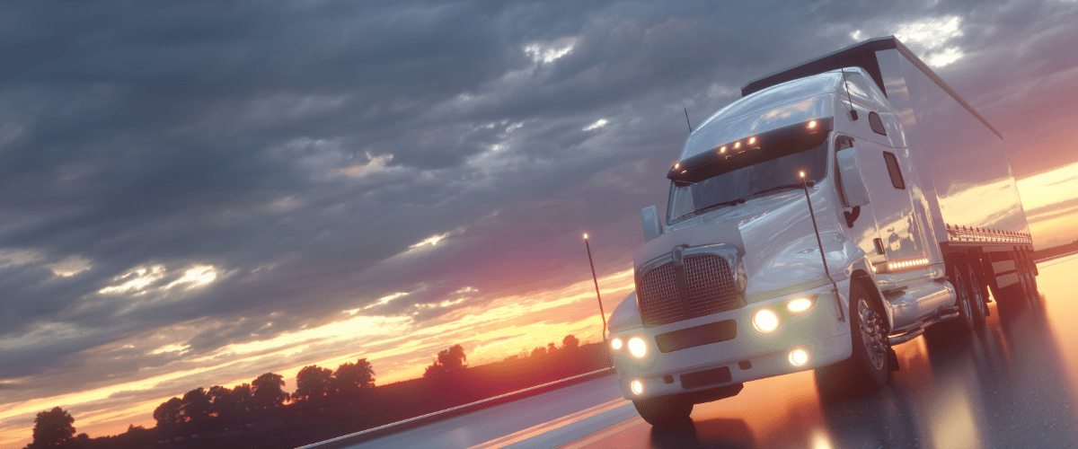 Truck driving on the road with sunset background